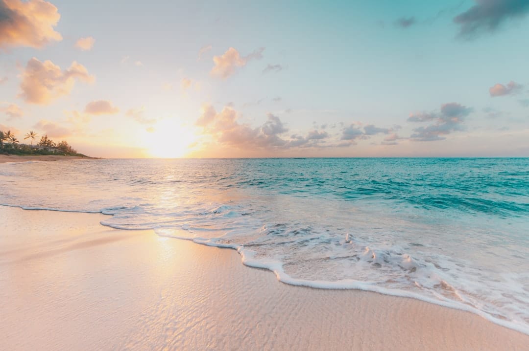 A near-empty beach on the North Shore of Oahu with the sky warming toward sunset
