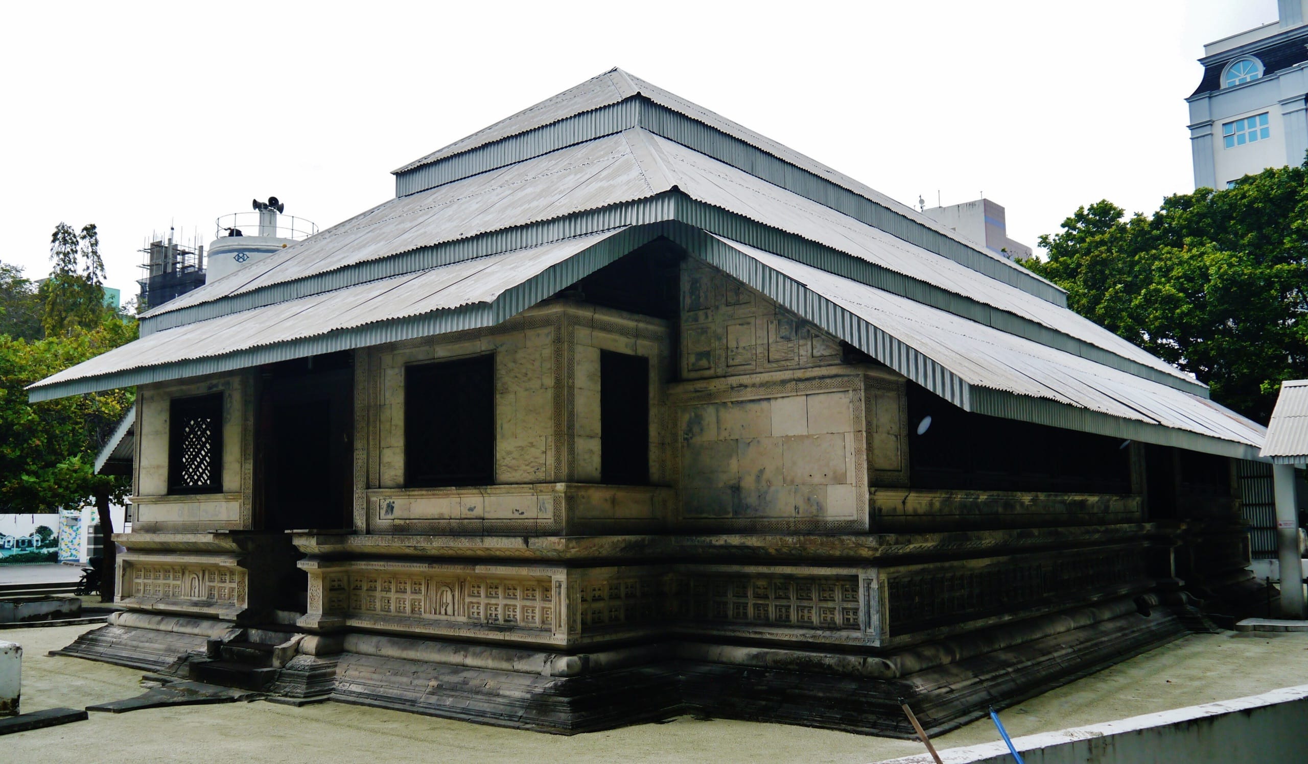The Old Friday Mosque in Malé, a low stone building under a tiered metal roof