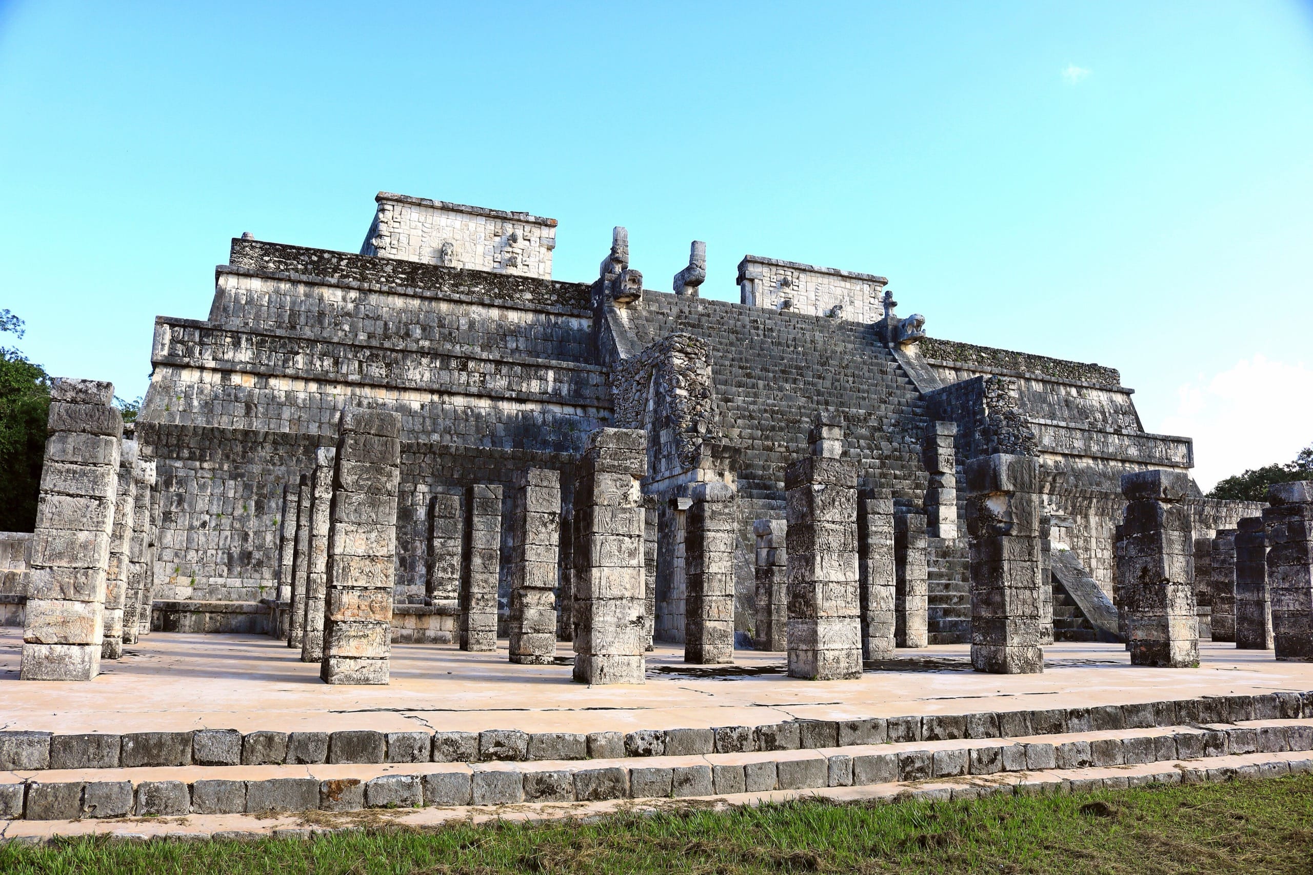 Rows of carved columns in front of the stepped Temple of the Warriors at Chichen Itza